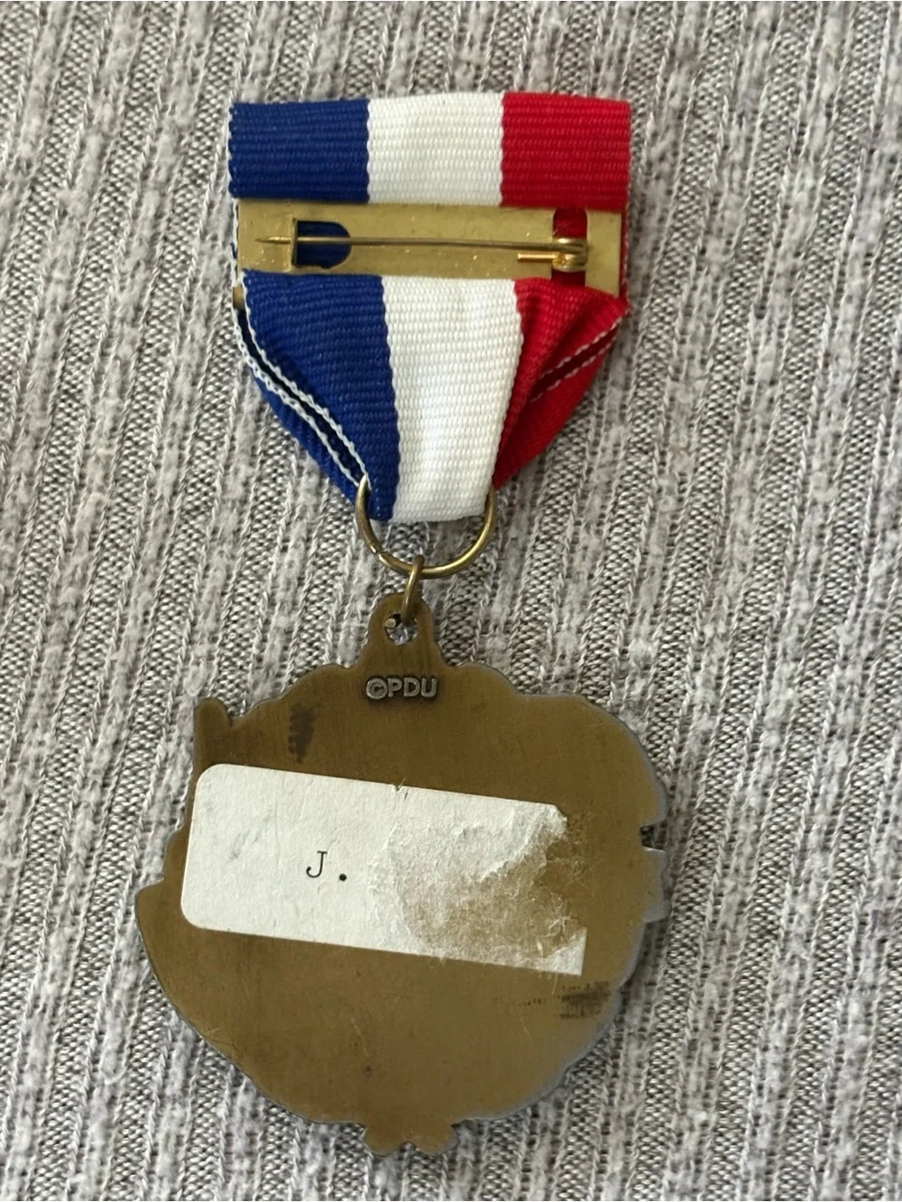 PDU marked bronze tone round football & helmet medal brooch w multicolor ribbon